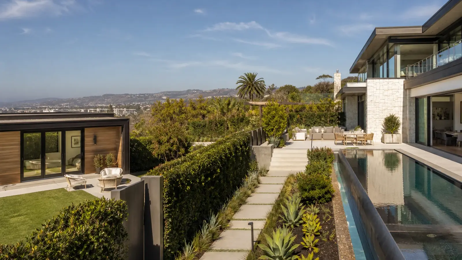 Detached ADU on a hillside pad with clay tile roof matching the main Newport Coast house