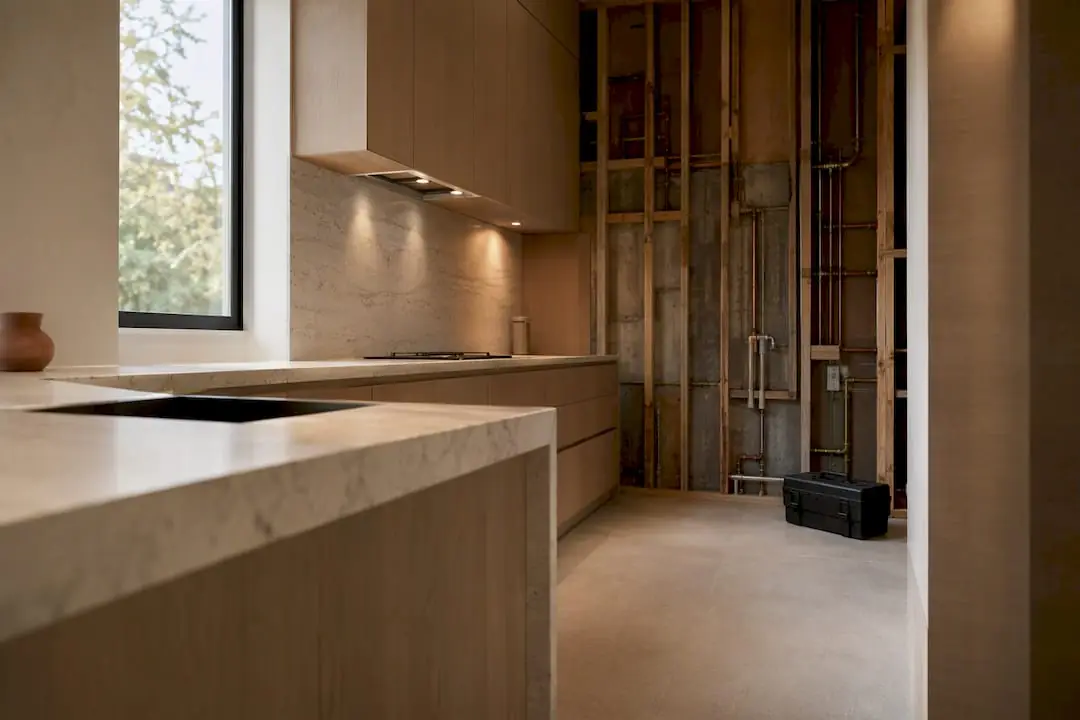Kitchen mid-remodel with new cabinet boxes installed and open walls ready for permit inspection