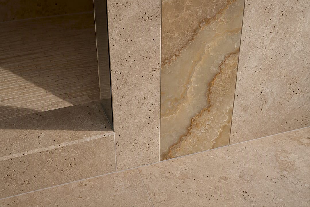 Natural travertine and onyx bathroom tile detail
